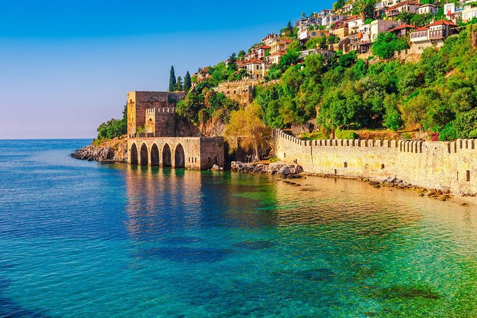 Alanya Boat Trip with Unlimited Soft Drinks and Lunch - Leaving Alanya Harbor beneath the Red Tower
