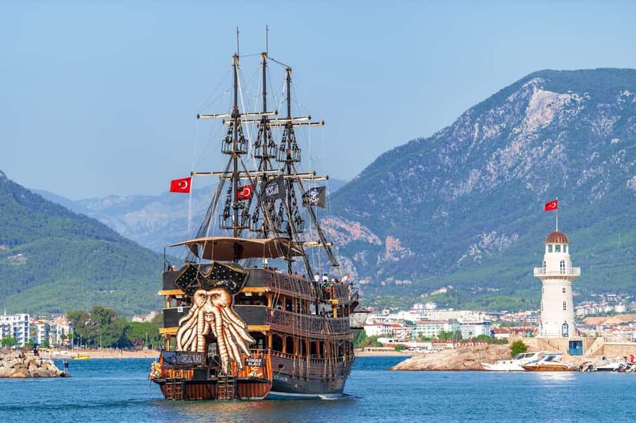 Alanya: Pirate Boat with Transfer, Lunch & Unlimited Drinks - Caves, cliffs, and the first swim