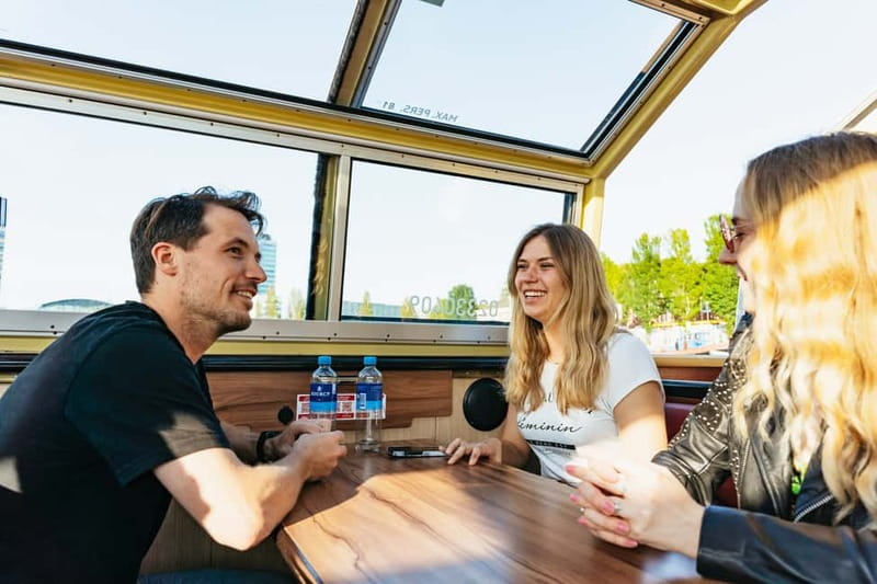 Amsterdam: City Centre Canal Cruise & Free Flower Cocktail - Audio guide, captain, and onboard comfort