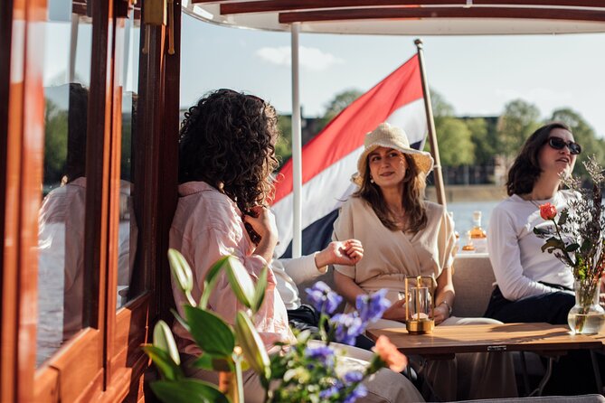 Amsterdam: Luxury Saloon Boat Cruise with Cocktails & Waffle - Locks, towers, and Amsterdam Central Station