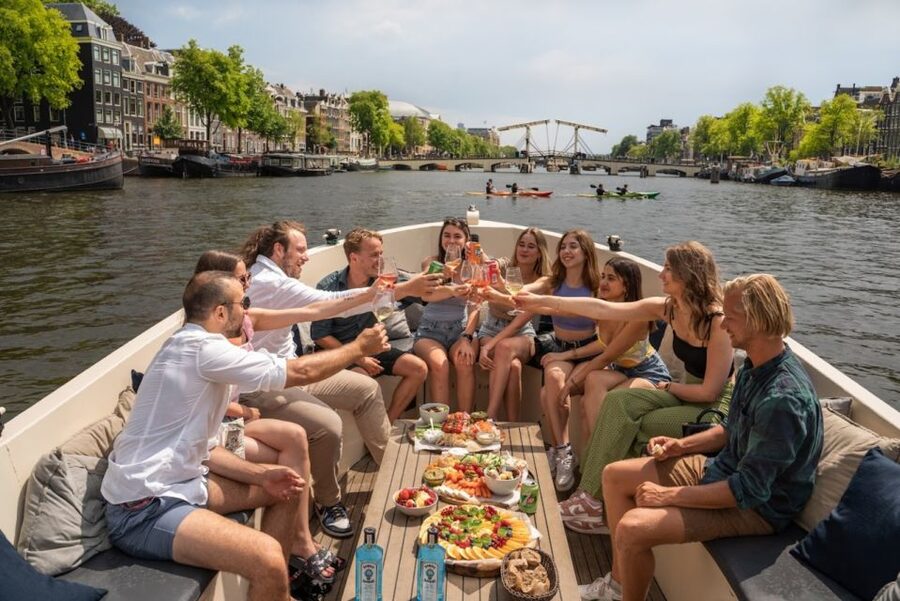 Amsterdam: Red-Light District Pub Crawl and Booze Boat Tour - Four pubs, free shots, and drinking games