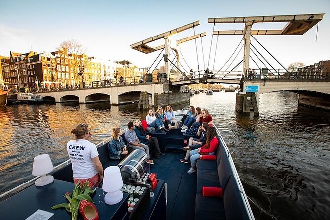 Amsterdam Sunset Canal Cruise with Live Guide and Open Bar - Sunset on the canals, with a drink in hand