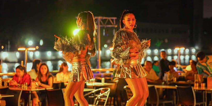 Bangkok: Carnival Dinner Cruise with Free-Flow Beer & Buffet - A party boat with Bangkok’s skyline as the backdrop