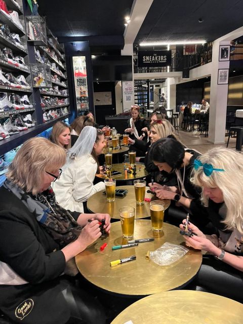 Brussels Tipsy Tour: Cocktail Making, Painting & Chocolates - Painting a Manneken Pis statue over beer and a shot