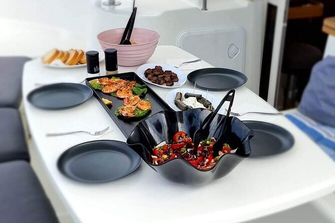 Catamaran Day & Sunset Cruises with meals Drinks and transportation - Passing Delos, the island you see but do not visit