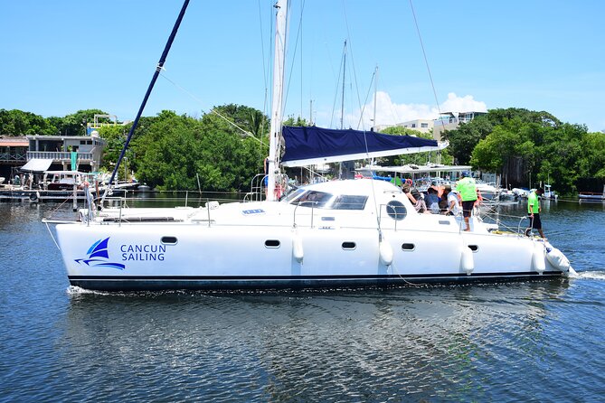 Catamaran Tour to Isla Mujeres, Open bar, Lunch, Snorkeling, Beach Club Included - What the $97 base cost delivers