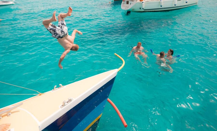Comino: Blue Lagoon Catamaran Cruise with Lunch and Open Bar - From relaxed sailing to a party at sea