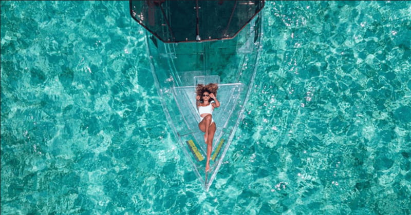 Explore the sea of cozumel in a transprent boat with drinks and snorkel. - Shipwrecks, coral, and fish below the floor