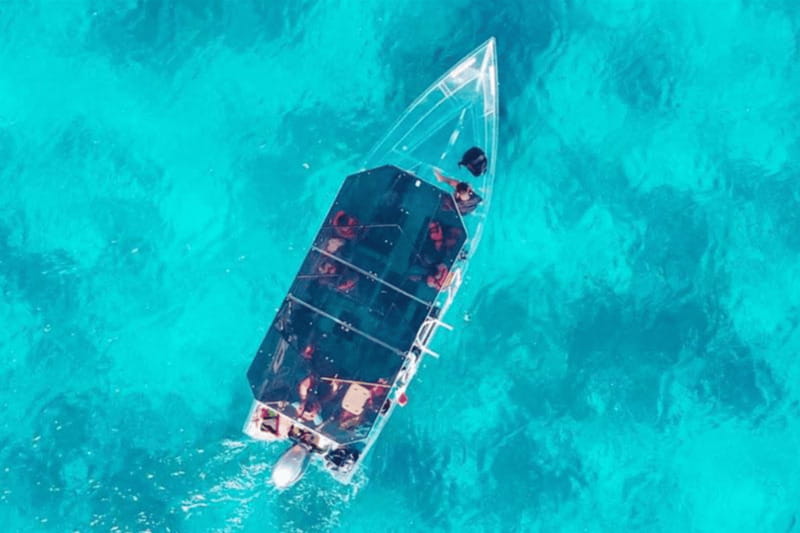 Explore the sea of cozumel in a transprent boat with drinks and snorkel. - Leaving San Miguel for the north side