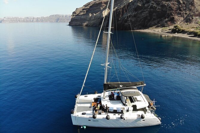 Half-Day Exclusive Catamaran Cruise in Santorini with Meal and Open Bar - Red Beach and Santorini’s southern cliffs