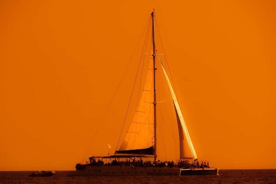 Isla Mujeres: Catamaran Ride with Open Bar, Snorkeling, and Lunch - Sailing from Cancun with a drink in hand