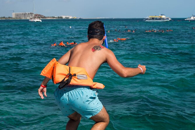 Isla Mujeres Catamaran Tour with Open Bar, Lunch and Snorkeling - Beach club, buffet, and time by the water