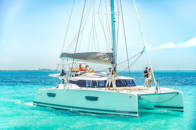 Isla Mujeres luxury catamaran with premium open bar and lunch - Pickup, check-in, and the reef tax