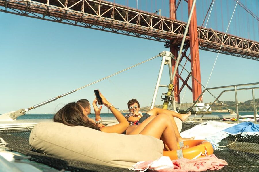 Lisbon: Catamaran Boat Party with Music, Open Bar & Dives - A floating party with Lisbon as the backdrop