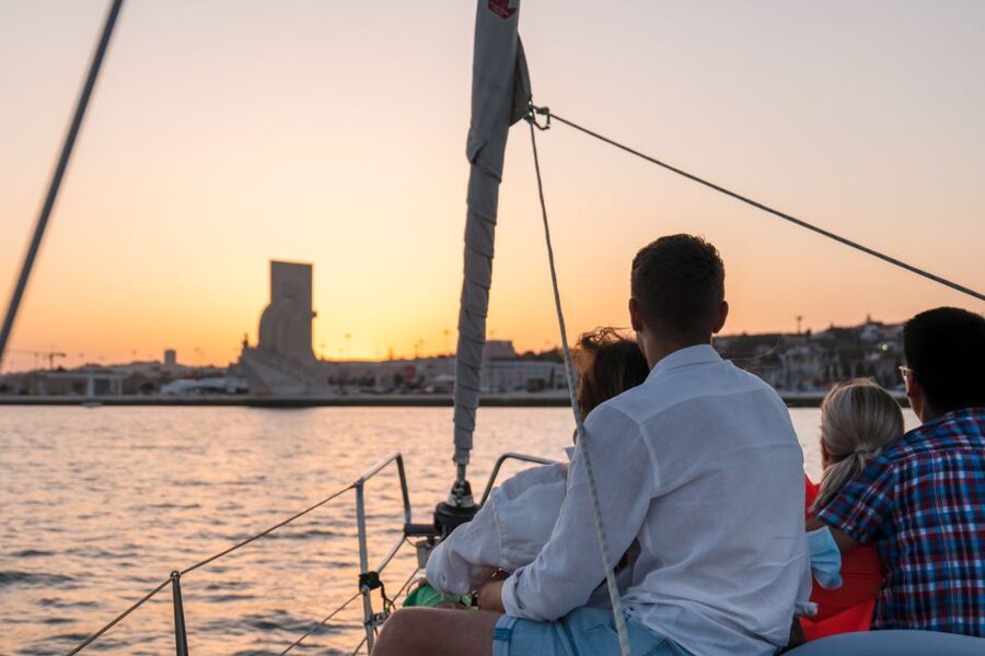 Lisbon: Daytime/Sunset/Night City Sailboat Tour with Drink - Under the 25 de Abril Bridge toward the city center