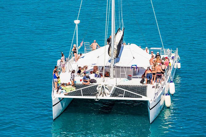 Live this unique experience. Catamaran to Isla Mujeres Tour. Open Bar included. - Buffet lunch at a private beach club