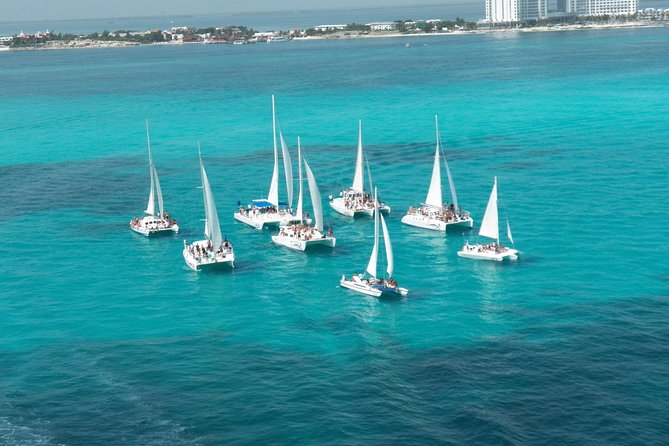 Live this unique experience. Catamaran to Isla Mujeres Tour. Open Bar included. - What the $55 price really covers