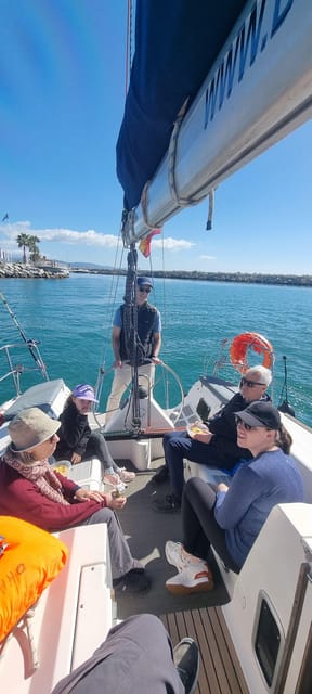 Marbella: Dolphin-Watching Sailboat Trip with Drinks, Snacks - Drinks, fruit, and the mood on board