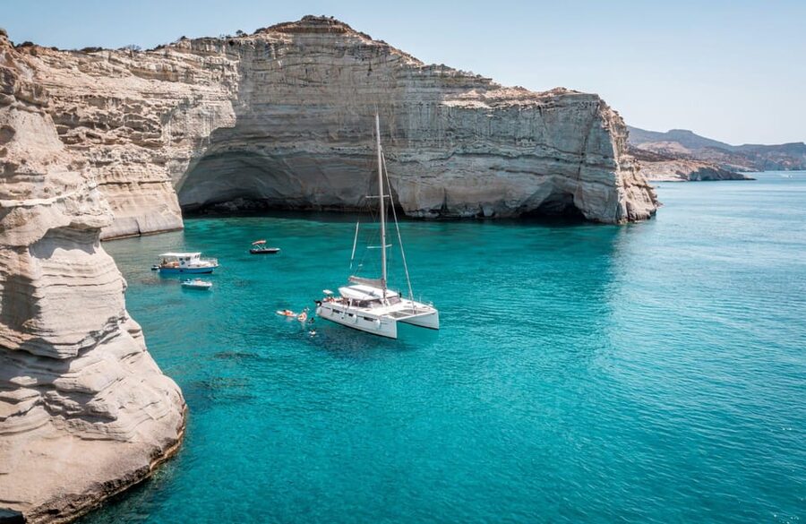 Milos: Full Day Luxury Catamaran with Full Meal & Open Bar - Galazia Nera and the clear water of Polyegos