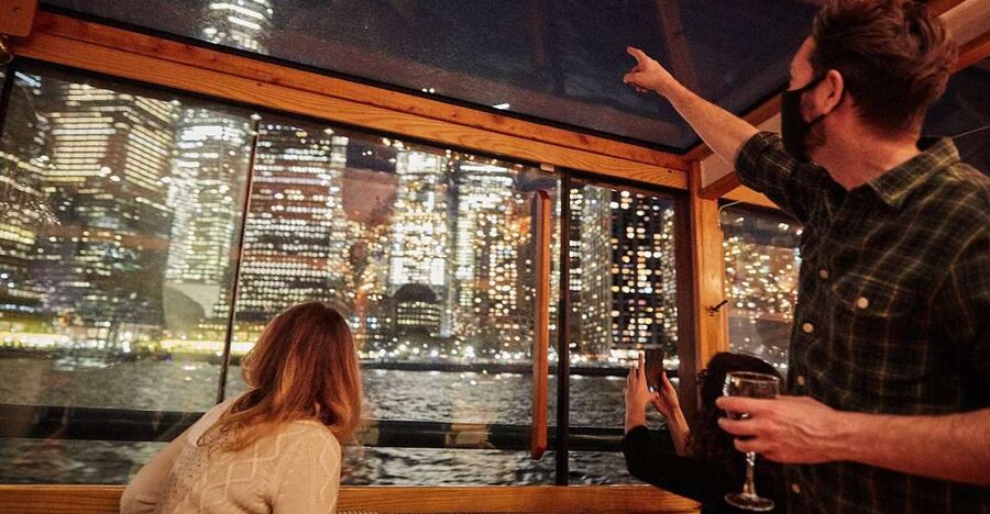 NYC: City Lights Yacht Cruise with Drink Included - Liberty Island and Ellis Island after dark
