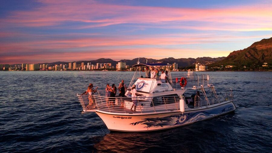 Oahu: Premium Waikiki Sunset Party Cruise with Live DJ - Waikiki lights after dark