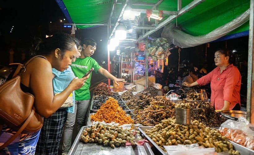 Phnom Penh: Evening Food Tour with Drinks & Tuk Tuk Included - Grilled chicken, sticky pork, and Khmer flavors