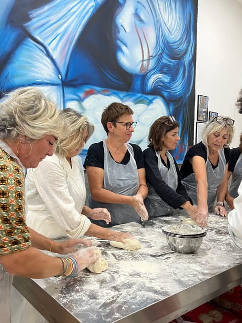 Pizza-Making Workshop by night with glass of wine - Adding sauce, mozzarella, and olive oil