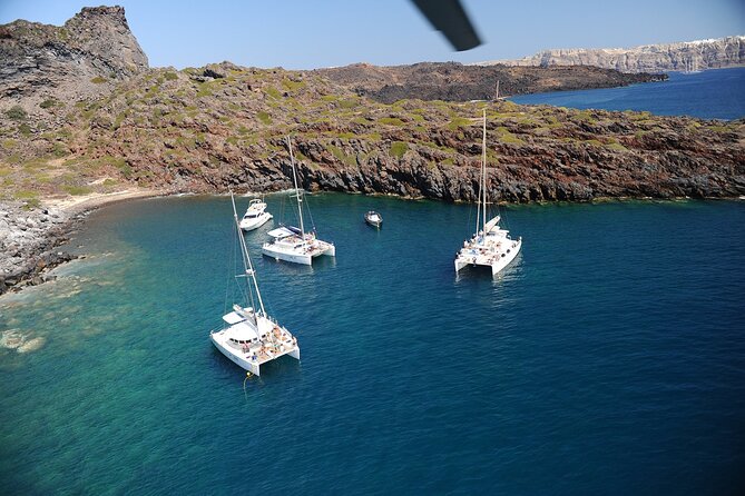 Santorini Classic Catamaran Cruise with BBQ, Drinks and Transfers - Caves, Indian Rocks, and the volcanic coast