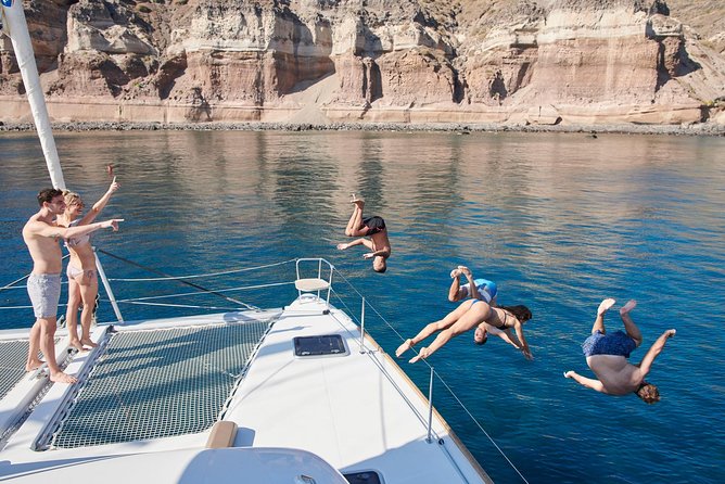 Santorini Gold Catamaran Cruise with BBQ, Drinks and Hotel Pickup - The volcano hot springs stop