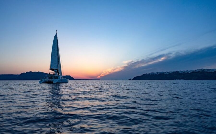 Santorini: Luxury Sunset Cruise with Dinner & Open Bar - Sailing past Thirassia and the caldera cliffs