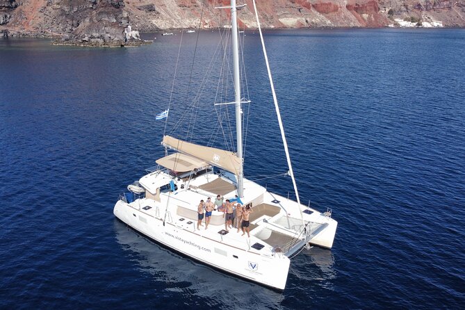 Santorini Platinum Catamaran Cruise with Meal, BBQ and Open Bar - The Akrotiri lighthouse and volcanic coast